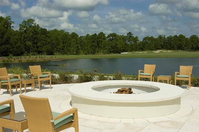 view of patio with a water view and a fire pit