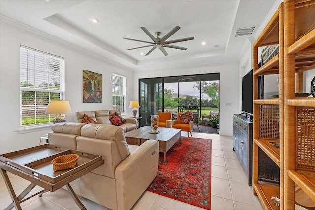 living room featuring light tile patterned floors, a raised ceiling, and ceiling fan