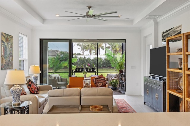 tiled living room featuring a raised ceiling, ceiling fan, and ornamental molding