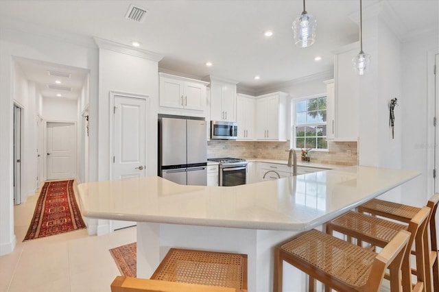 kitchen featuring pendant lighting, a kitchen breakfast bar, decorative backsplash, light tile patterned floors, and stainless steel appliances