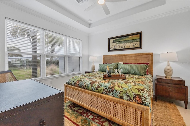 tiled bedroom with ceiling fan, a raised ceiling, and crown molding