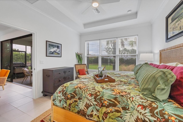 bedroom with access to exterior, ceiling fan, a tray ceiling, light tile patterned floors, and ornamental molding