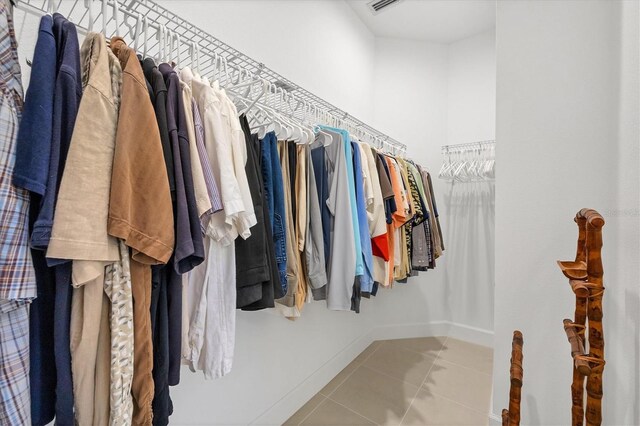 spacious closet featuring light tile patterned floors