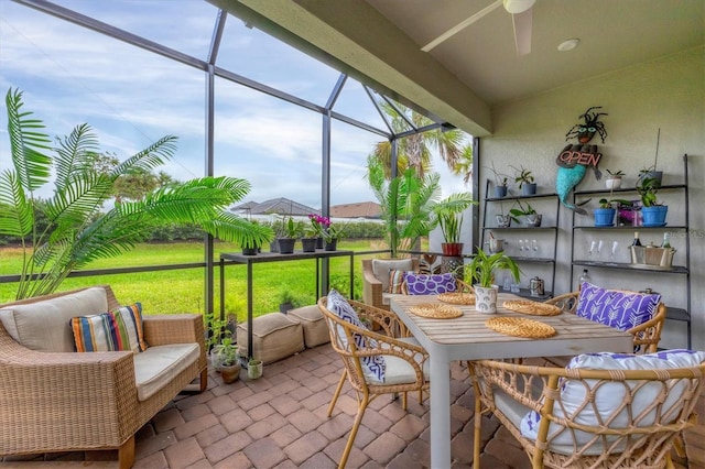 sunroom with ceiling fan and outdoor dining space