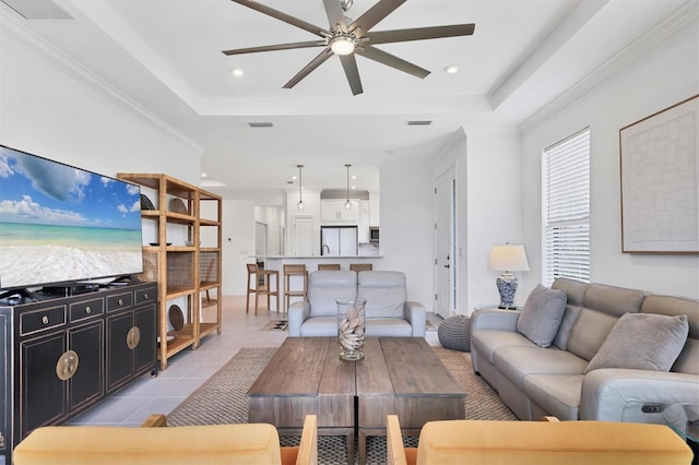 living room featuring ceiling fan, a tray ceiling, light tile patterned floors, and recessed lighting