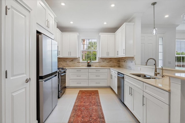 kitchen with stainless steel appliances, a sink, ornamental molding, healthy amount of natural light, and decorative backsplash