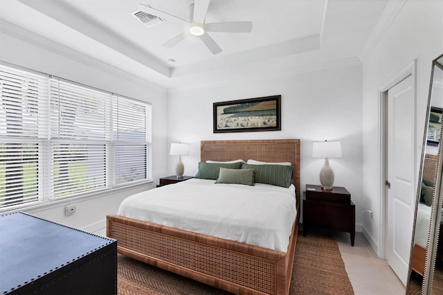 bedroom with a raised ceiling, baseboards, ceiling fan, and tile patterned floors