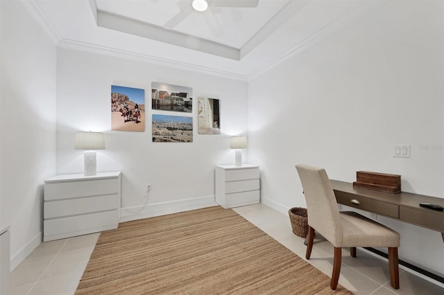 office featuring tile patterned floors, a ceiling fan, a raised ceiling, ornamental molding, and baseboards