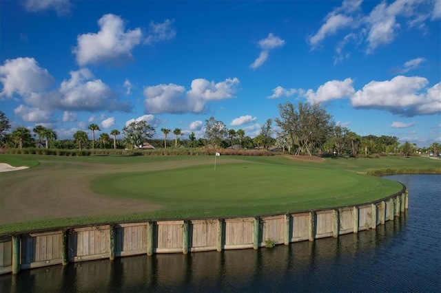 view of community with view of golf course and a water view