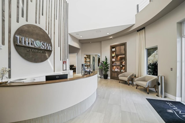 reception with a towering ceiling and recessed lighting