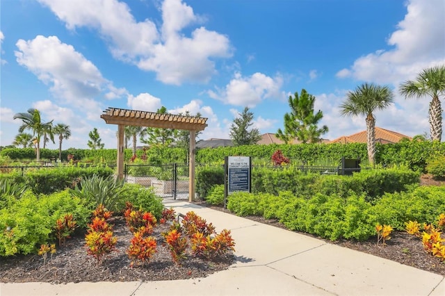 view of community featuring a gate, fence, and a pergola