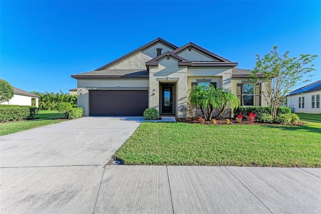 view of front of home featuring a garage and a front yard