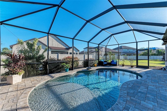 view of pool featuring a patio, glass enclosure, and a lawn