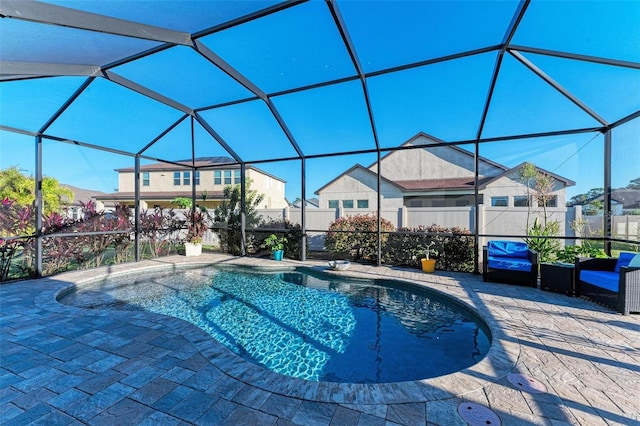 view of swimming pool with glass enclosure and a patio area