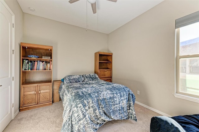 bedroom featuring ceiling fan, light colored carpet, and lofted ceiling