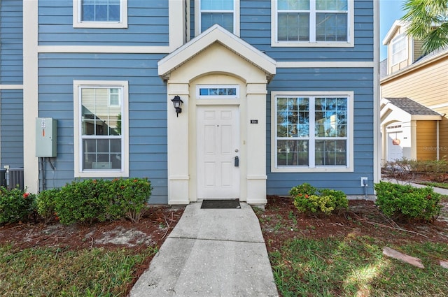 view of exterior entry with central AC unit