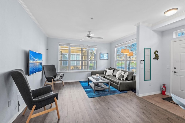 living room featuring wood-type flooring, ceiling fan, and ornamental molding