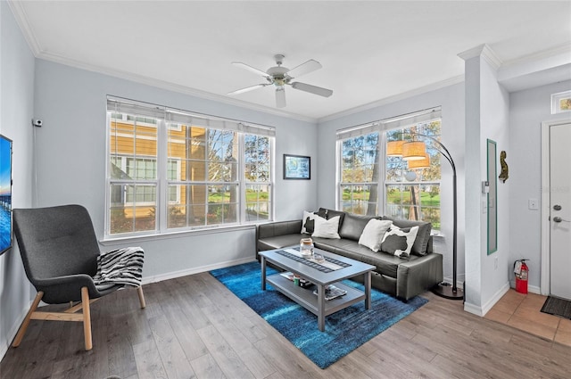 living room with ceiling fan, a wealth of natural light, and light hardwood / wood-style flooring