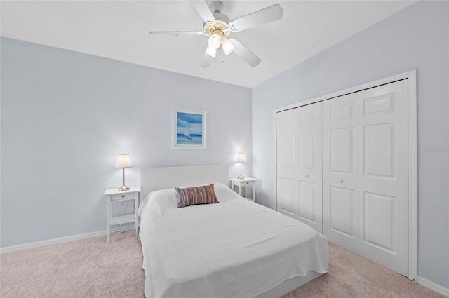 carpeted bedroom featuring ceiling fan and a closet