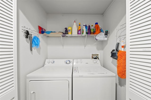 clothes washing area featuring washer and dryer