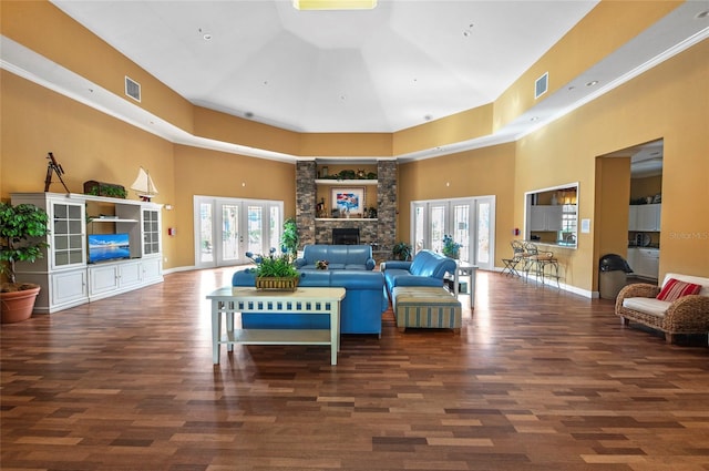 living room featuring french doors, a towering ceiling, and dark hardwood / wood-style floors