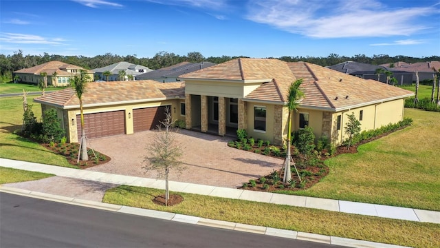 ranch-style home with a garage and a front lawn