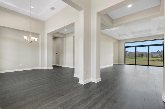 unfurnished room featuring beam ceiling, dark hardwood / wood-style flooring, coffered ceiling, and a notable chandelier