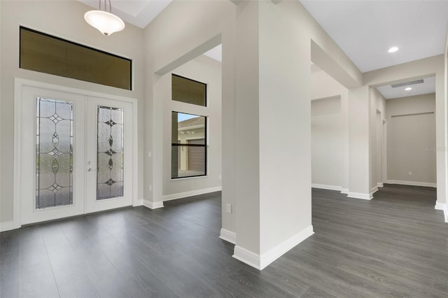 foyer with french doors and dark hardwood / wood-style floors