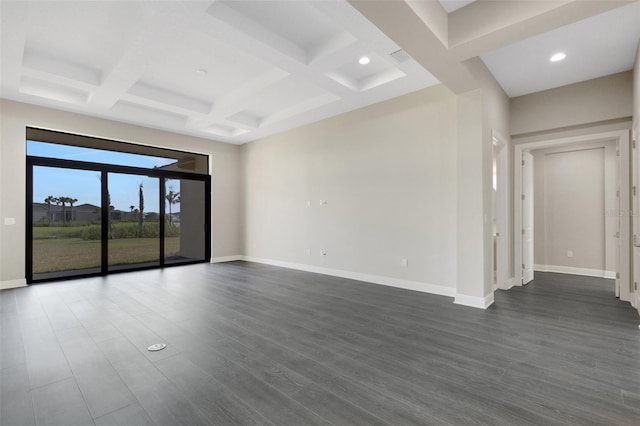 spare room featuring beam ceiling, dark hardwood / wood-style flooring, and coffered ceiling