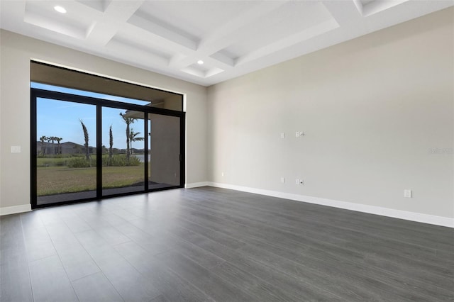 empty room featuring beamed ceiling, dark wood-type flooring, and coffered ceiling