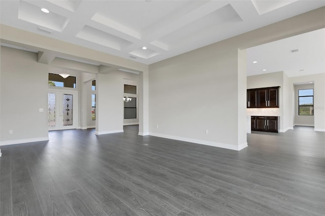 unfurnished living room with beamed ceiling, dark wood-type flooring, and coffered ceiling