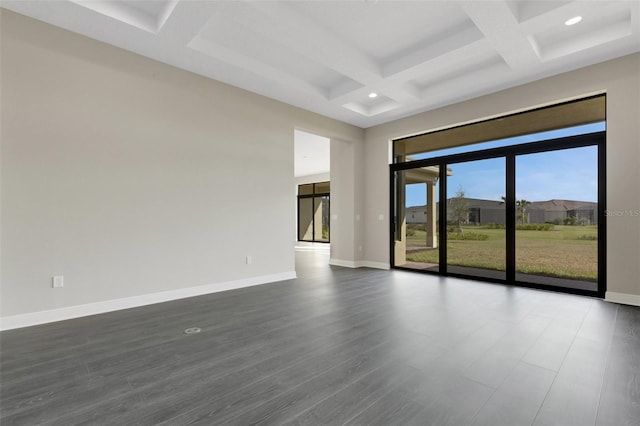 spare room with beamed ceiling, dark wood-type flooring, and coffered ceiling