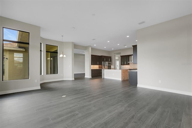 unfurnished living room featuring dark hardwood / wood-style flooring