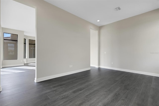 empty room with dark hardwood / wood-style floors