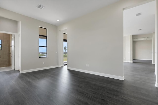 unfurnished room featuring dark wood-type flooring