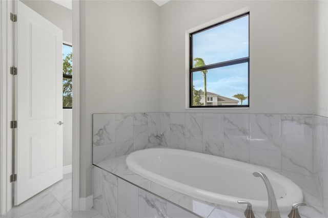 bathroom featuring tiled tub