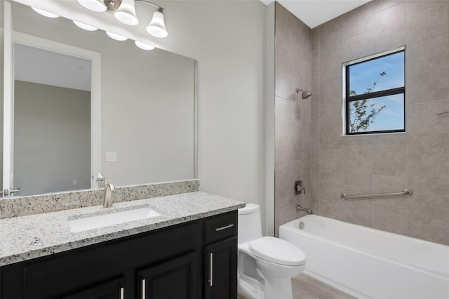 full bathroom with toilet, vanity, and tiled shower / bath