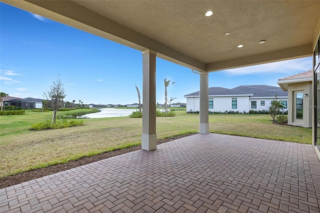 view of patio with a water view