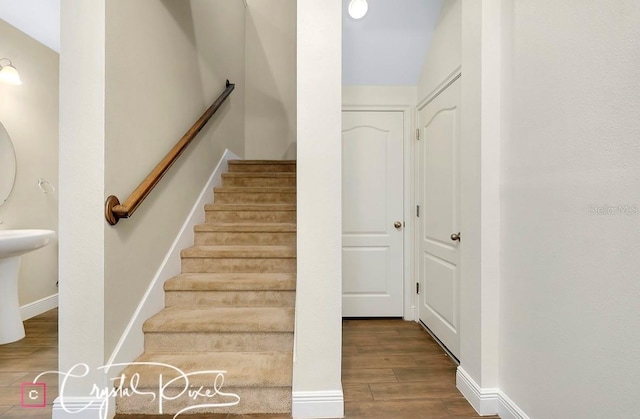 stairway with hardwood / wood-style floors