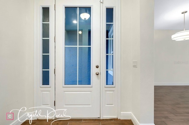 doorway with dark hardwood / wood-style flooring