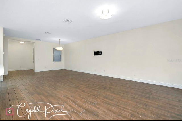 unfurnished room featuring dark wood-type flooring