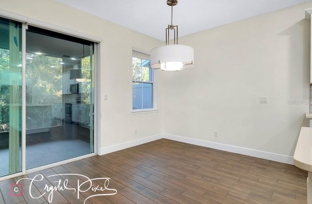 unfurnished room with wood-type flooring