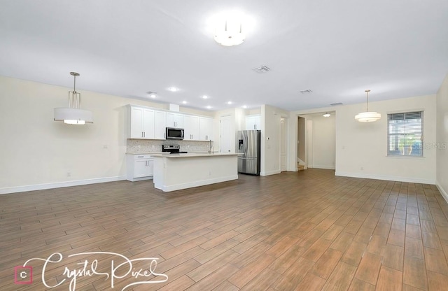 kitchen featuring white cabinetry, pendant lighting, stainless steel appliances, and light hardwood / wood-style flooring