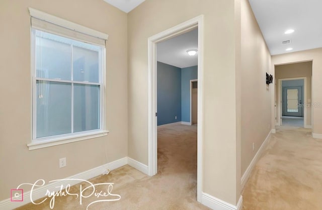 corridor with light colored carpet