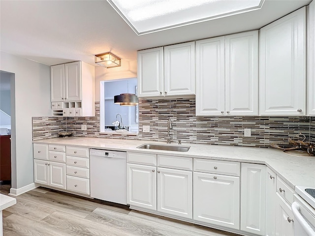 kitchen with white cabinetry, white appliances, sink, and light hardwood / wood-style flooring