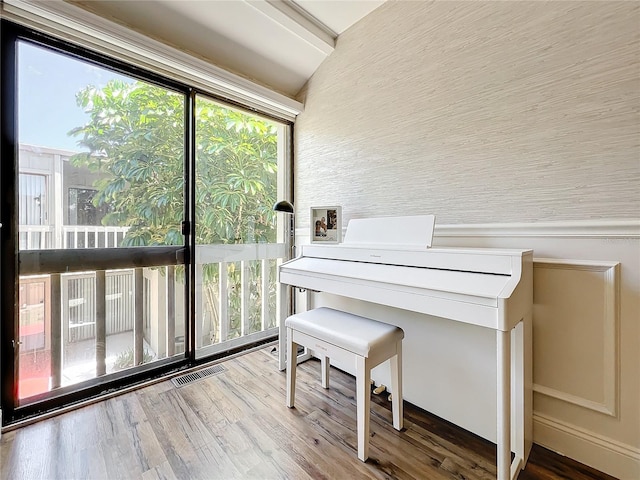 misc room with hardwood / wood-style floors and vaulted ceiling