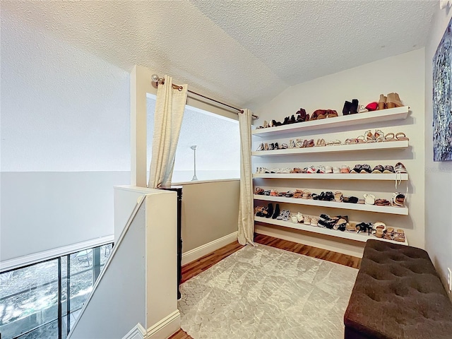 interior space featuring hardwood / wood-style floors and vaulted ceiling