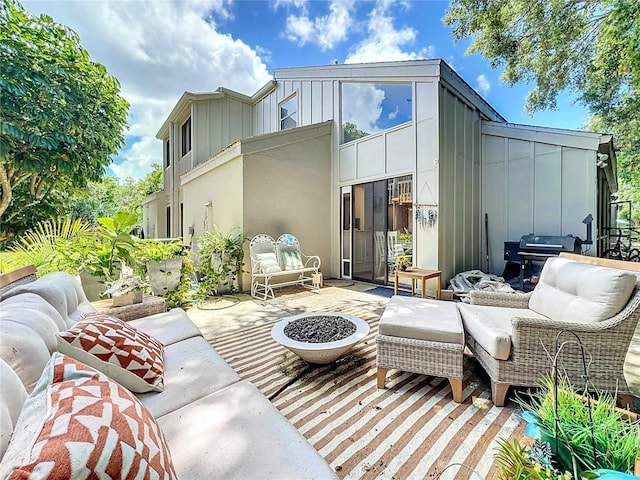 back of house featuring a fire pit and a patio area