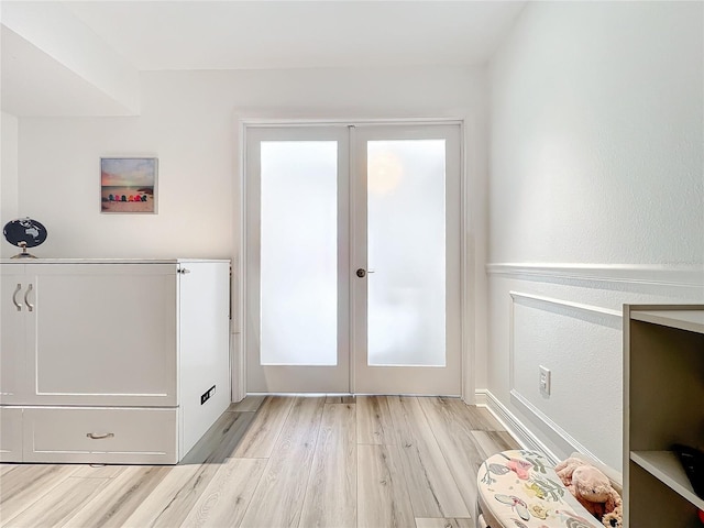 doorway featuring light wood-type flooring and french doors