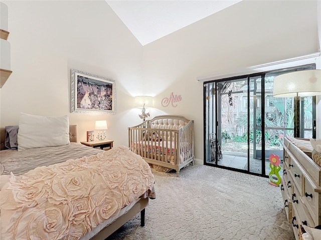 bedroom featuring carpet flooring, access to outside, and lofted ceiling